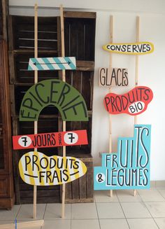 three wooden signs are displayed in front of a bookcase