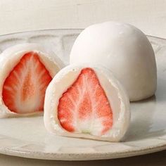 two pieces of fruit on a white plate