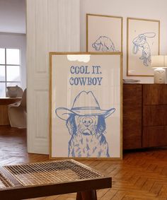 there is a poster on the wall in the living room that says cool it cowboy