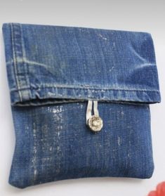 an old pair of blue jeans with a small metal button on the front and side