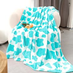 a blue and white blanket sitting on top of a chair