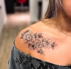 a woman with a flower tattoo on her shoulder