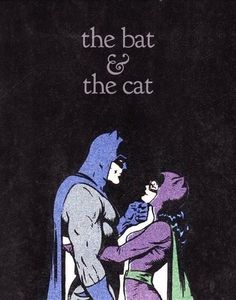 the batman and the cat are standing next to each other