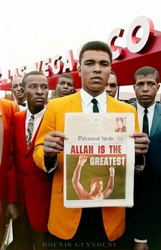 a man in a yellow suit holding up a sign that says aloh is the greatest