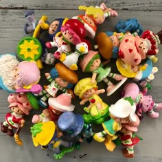 a pile of small toy figurines sitting on top of a wooden table