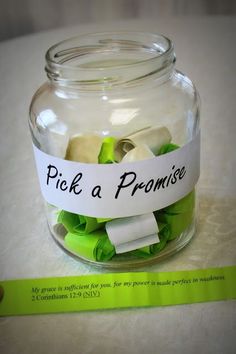 a glass jar filled with green and white paper