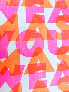 an orange and pink poster with letters on it