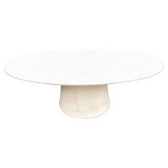 an oval white marble table on a white background