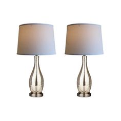 pair of glass table lamps with white shades on each lamp and the base is silver