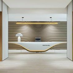 an office lobby with a large white desk and brown wallpaper on the walls behind it