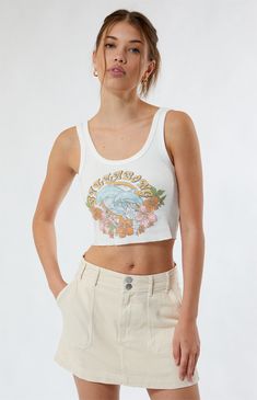 The Tropical Feelings Tank Top from Billabong is perfect for the warm weather. It features a Billabong dolphin graphic on the front, a raw cut hem, and a cropped fit.


	Solid color tank top
	Scoop neckline
	Fixed straps
	Billabong graphic
	Raw cut hem
	Cropped length
	Fitted
	100% cotton
	Machine washable
	Model is wearing a size small
	Model measurements: 5’8.5” height, 31.5” bust, 24” waist, 35.5” hips Billabong Clothing, Dolphin Graphic, Bedroom Stuff, Outfit Inspo Summer, Billabong Women, Top Graphic Tees, Fit Check, White Tank Top, Summer Tops