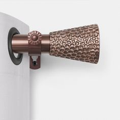 a close up of a toilet paper roll on a wall with a metal holder attached to it