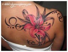 a woman's back tattoo with pink flowers and swirls on the side,