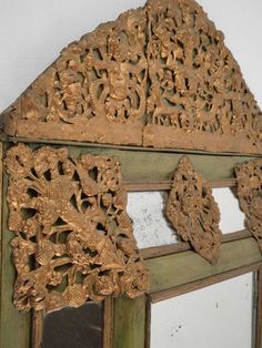 an old wooden window with carvings on it