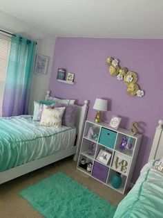 two beds in a room with purple walls and green rugs on the floor next to each other