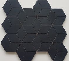 a black hexagonal tile pattern on a white wall