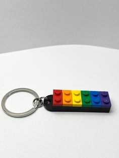 a lego keychain with four different colored bricks on it's front and back sides