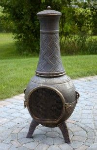 an old fashioned stove sitting on top of a brick patio