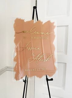 an easel holding a sign that says welcome to our beginning