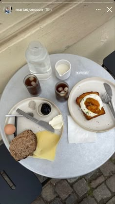 an image of a plate with food on it sitting on a table next to some drinks