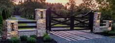 a stone and wood gate with lights on it