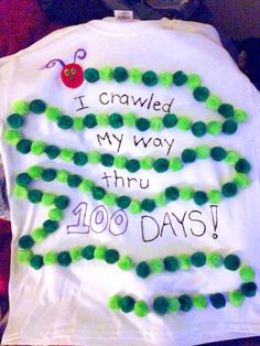 a white shirt with green beads on it and the words i crawled my way thru 100 days