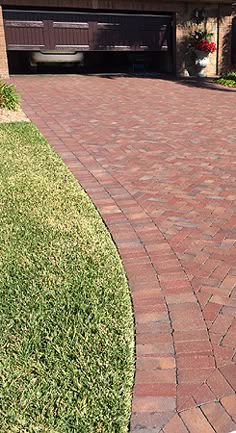 a fire hydrant in front of a brick driveway