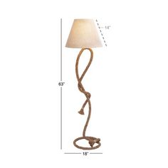 a floor lamp with a white shade on the bottom and a brown cord attached to it