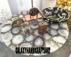 there is a table made out of rocks and other things on the table with words that read galaxy handcrafts art