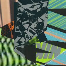 an abstract painting with black, green and blue stripes on it's edges is shown in the foreground