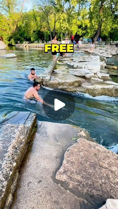 a man is swimming in the water near rocks