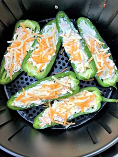 some green peppers with cheese on them in a frying pan