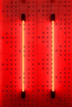 red lights are shining in the middle of a room with letters and numbers on it