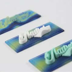 three different types of toothpaste sitting on top of blue and green plastic holders