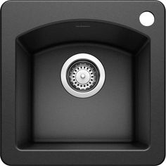 a black sink with a drain in the center and an under - mount faucet