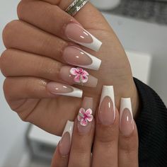 a woman's hands with french manies and pink flowers on their nails,