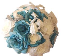 a bridal bouquet with blue and white flowers in it's center, on a white background