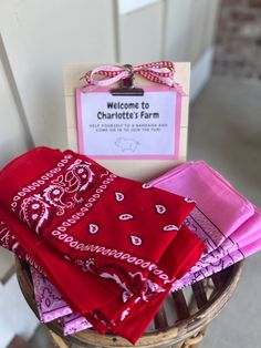 red and pink bandannas in a basket with welcome to charlotte's farm sign