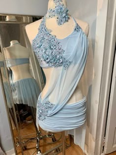 a mannequin with a dress on it in front of a mirror