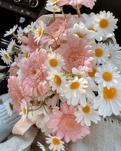 a bouquet of daisies and other flowers in a car