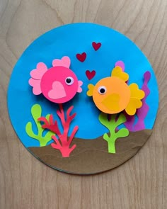 a paper plate with two fish and corals on it