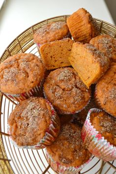 a basket filled with muffins covered in powdered sugar