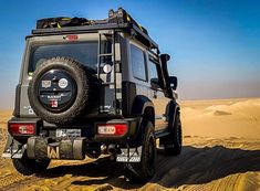 a black jeep is driving through the desert