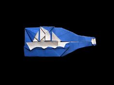 an origami boat floating on top of water