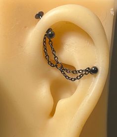 an ear is shown with chains attached to it