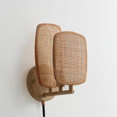 a pair of wooden chairs sitting on top of a wall