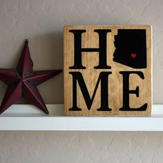 a wooden block with the word home on it and a red star next to it