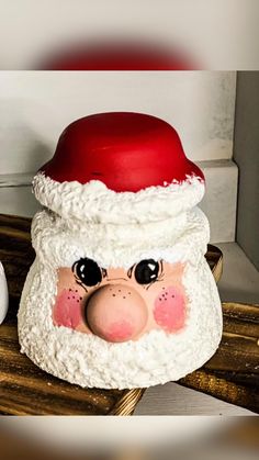 a santa claus hat sitting on top of a wooden table