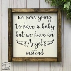 a framed sign with the words we were going to have a baby but we have an angel instead