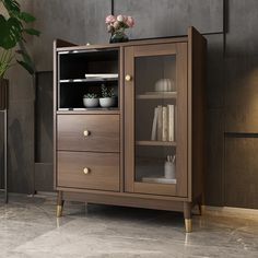 a wooden cabinet with glass doors and drawers in a room next to a potted plant